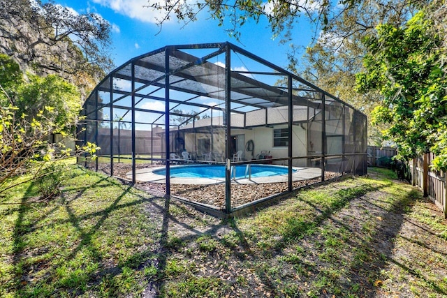 view of pool with a lanai, a fenced backyard, a fenced in pool, and a lawn