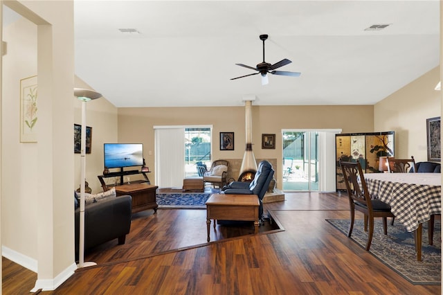 living room featuring visible vents, lofted ceiling, wood finished floors, and a ceiling fan