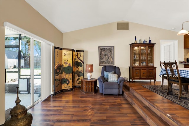 living area with visible vents, lofted ceiling, and dark wood-style flooring