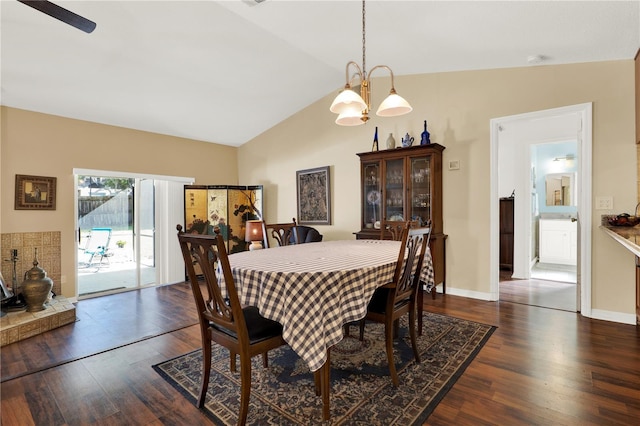 dining area with vaulted ceiling, baseboards, and dark wood-style flooring