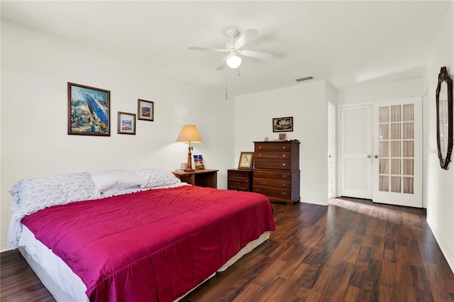 bedroom with visible vents, baseboards, a ceiling fan, and wood finished floors