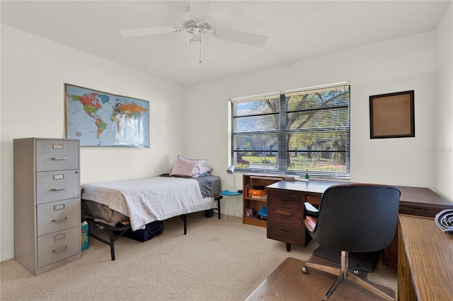 bedroom with a ceiling fan and light colored carpet