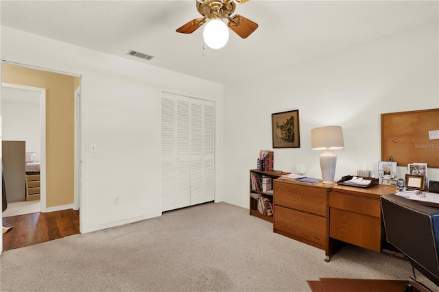 office with visible vents, baseboards, a ceiling fan, and carpet floors