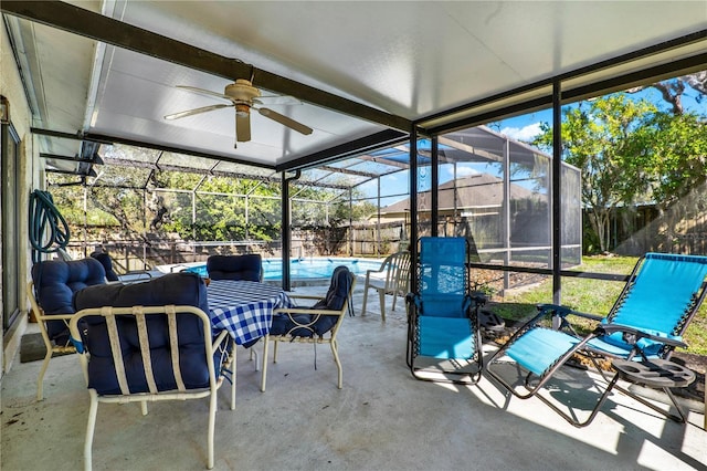 sunroom featuring a ceiling fan