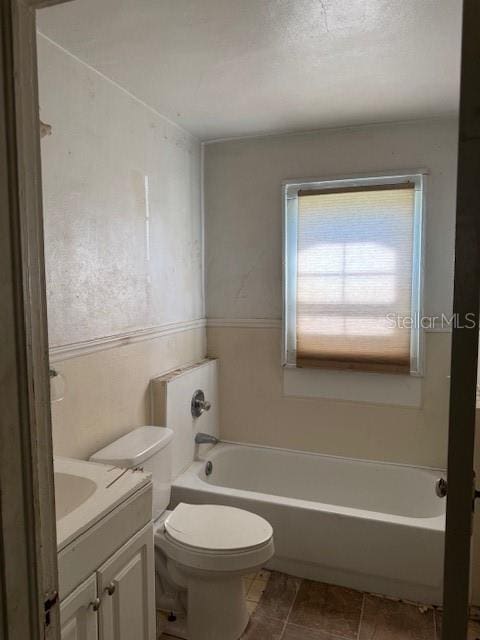 full bathroom with toilet, tile patterned floors, a bathing tub, and vanity