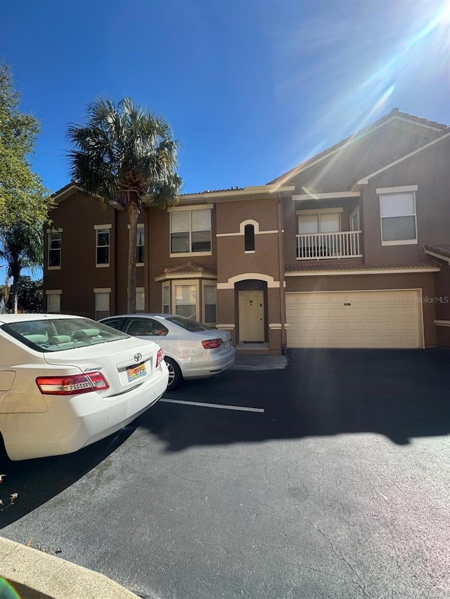 view of front of home featuring stucco siding and uncovered parking