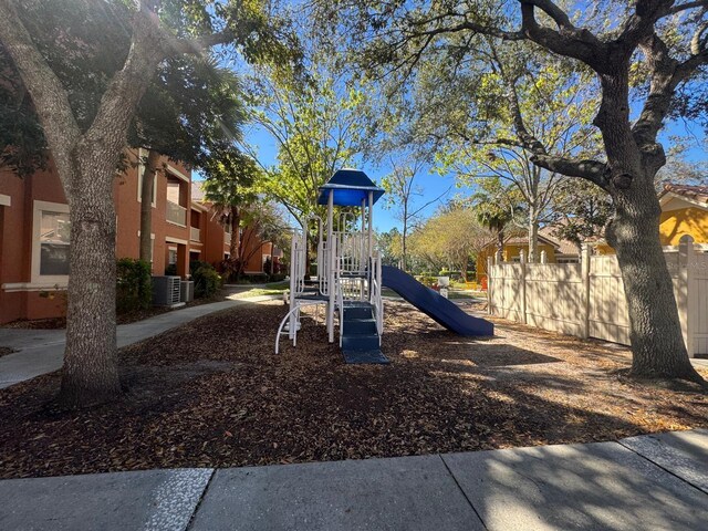 community jungle gym featuring central AC unit and fence