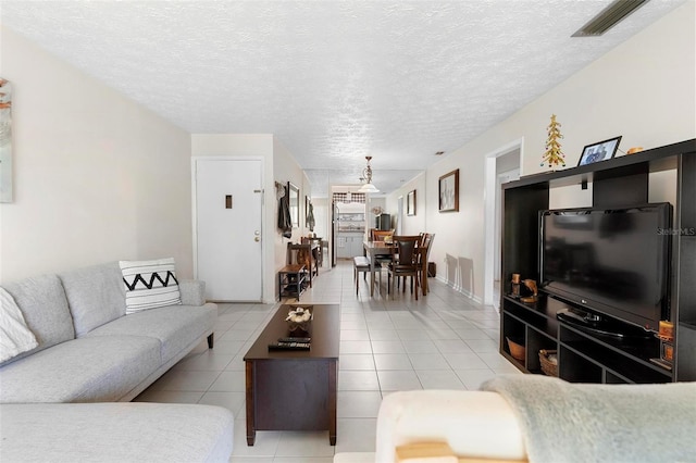 living room with light tile patterned floors and a textured ceiling