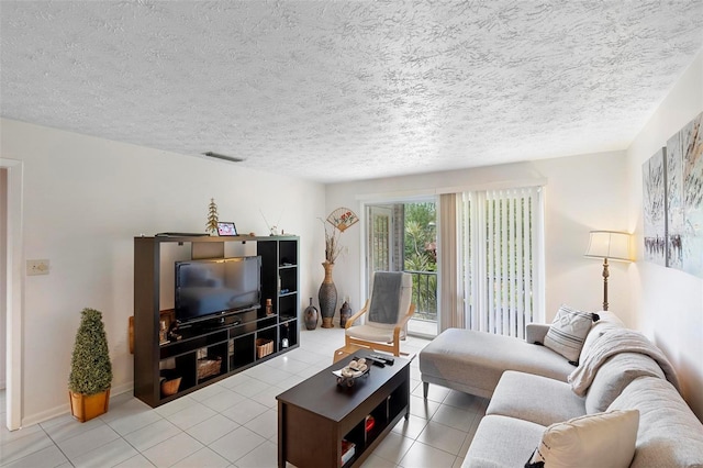 tiled living room featuring visible vents and a textured ceiling