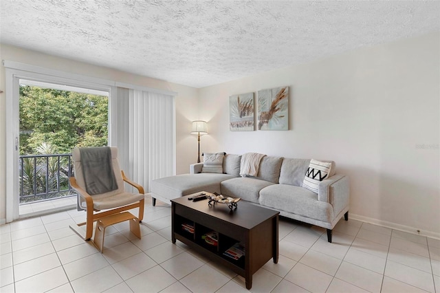 living room featuring light tile patterned floors, baseboards, and a textured ceiling