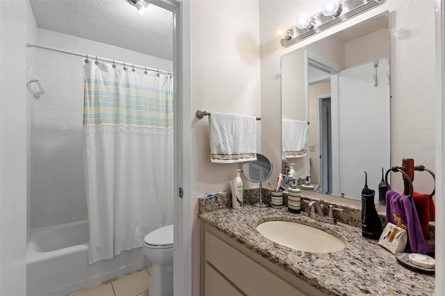 full bath featuring toilet, shower / bath combo with shower curtain, vanity, a textured ceiling, and tile patterned flooring