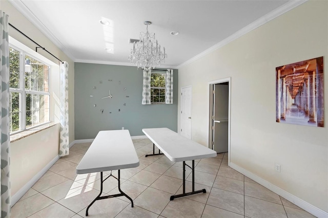 dining room featuring light tile patterned floors, ornamental molding, a notable chandelier, and baseboards