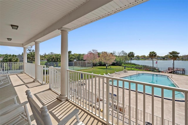 balcony with a water view and a patio area