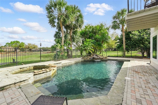 view of pool featuring a fenced in pool, a fenced backyard, a patio, and an in ground hot tub