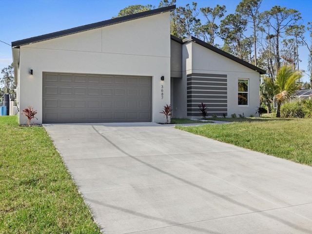 view of front of house featuring a garage, a front yard, concrete driveway, and stucco siding