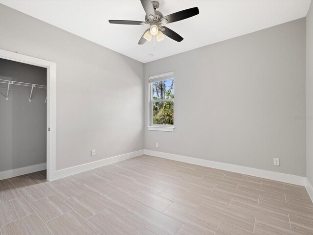 unfurnished bedroom featuring a ceiling fan, a closet, and baseboards