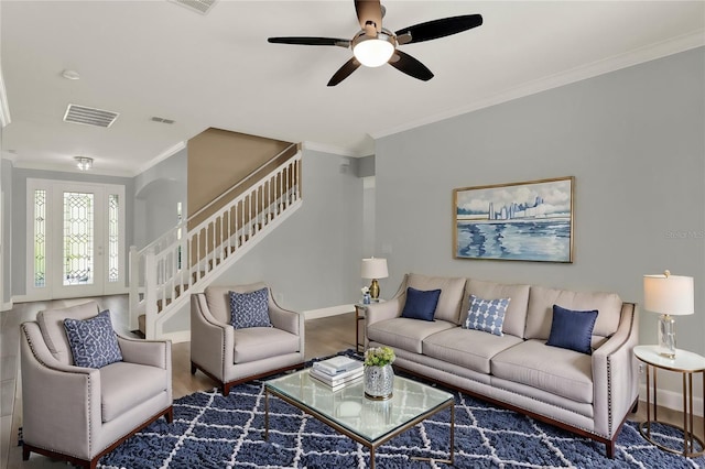 living area featuring ornamental molding, visible vents, baseboards, and stairs