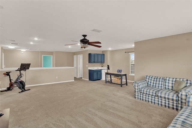 living room featuring ceiling fan, recessed lighting, light colored carpet, and baseboards