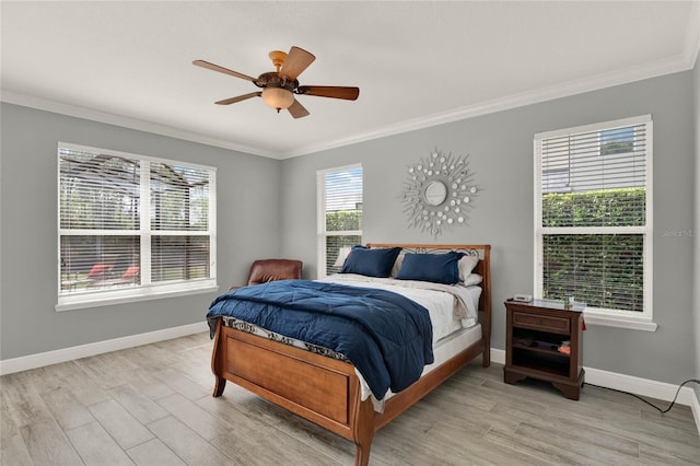 bedroom featuring ornamental molding, light wood-type flooring, and baseboards