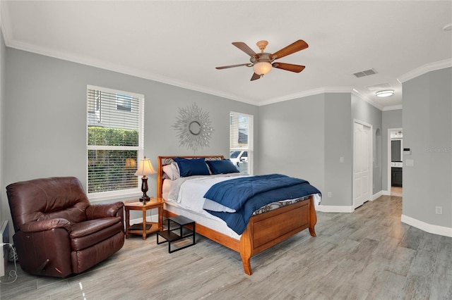 bedroom with light wood finished floors, visible vents, ornamental molding, a ceiling fan, and baseboards