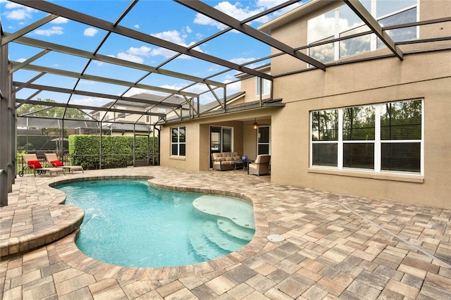 view of swimming pool with a fenced in pool, glass enclosure, and a patio