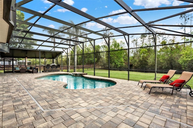 view of swimming pool with outdoor dry bar, a patio, a yard, and glass enclosure