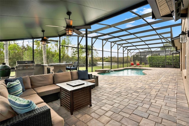 outdoor pool with an outdoor hangout area, exterior kitchen, a patio area, and a lanai