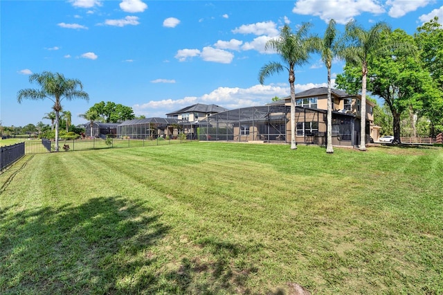 view of yard with a lanai and a fenced backyard