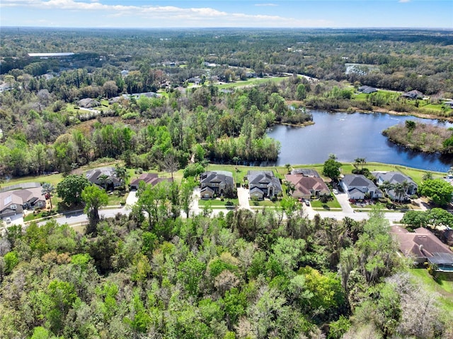 aerial view featuring a water view, a residential view, and a wooded view