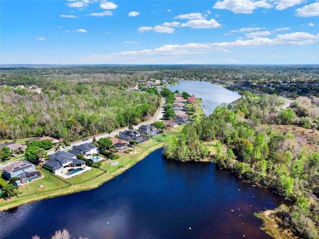 birds eye view of property with a forest view and a water view