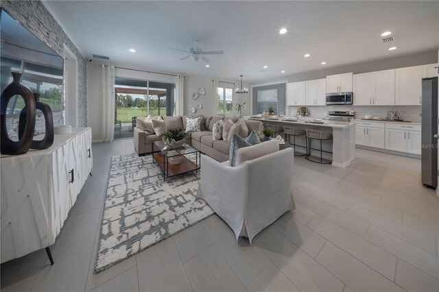 1578 Sky Lakes Dr, Saint Cloud, FL 34769 - living area with ceiling fan with notable chandelier, visible vents, and recessed lighting