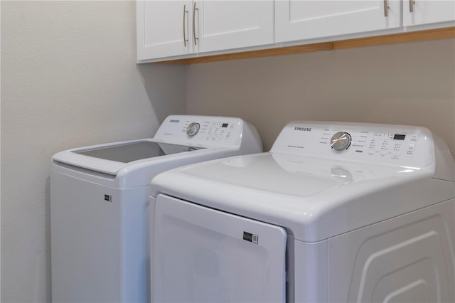 1578 Sky Lakes Dr, Saint Cloud, FL 34769 - laundry room with washing machine and clothes dryer and cabinet space