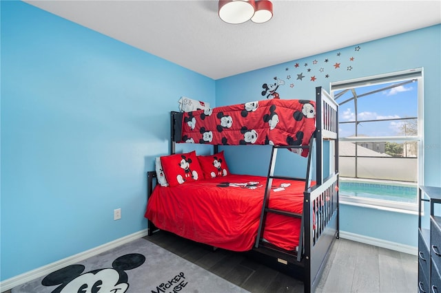 bedroom featuring baseboards and wood finished floors