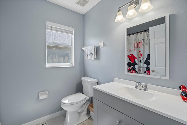 bathroom with visible vents, baseboards, toilet, tile patterned floors, and vanity