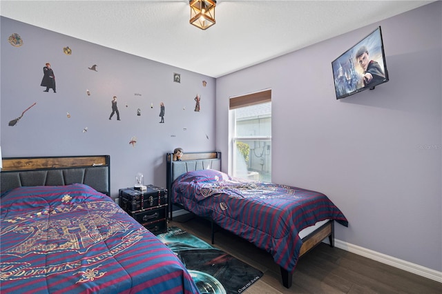 bedroom with wood finished floors and baseboards