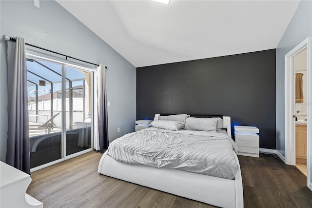 bedroom with baseboards, dark wood-style floors, vaulted ceiling, and access to outside