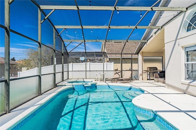 view of pool featuring glass enclosure, a patio, fence, and a pool with connected hot tub