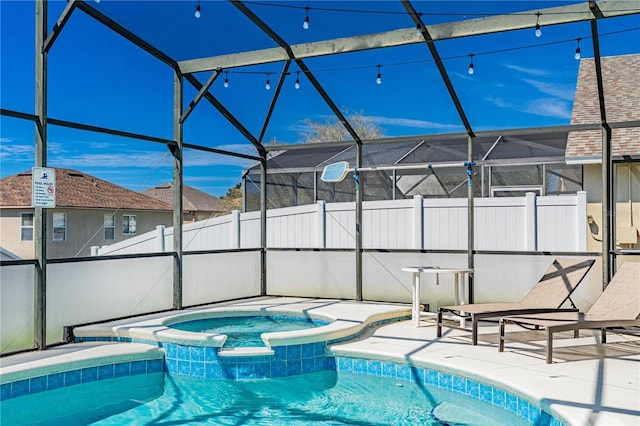 view of pool featuring a patio area, a pool with connected hot tub, and a lanai