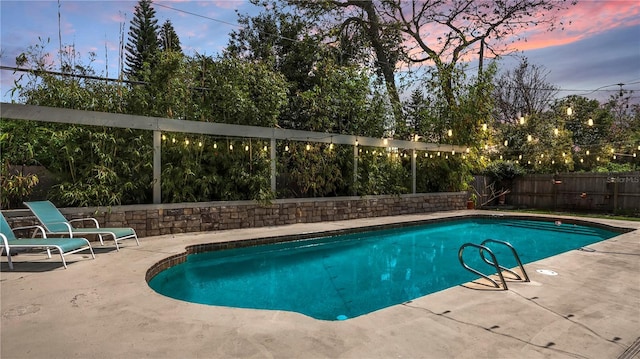 view of pool featuring a fenced backyard, a fenced in pool, and a patio