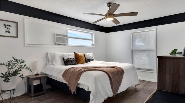 bedroom with baseboards, a ceiling fan, wood finished floors, a wall mounted air conditioner, and a textured ceiling