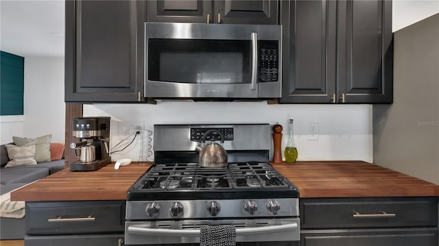 kitchen featuring butcher block countertops and appliances with stainless steel finishes