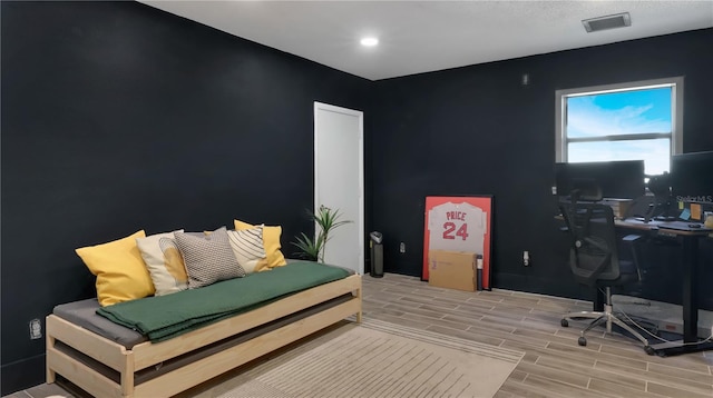 office space featuring wood finish floors and visible vents