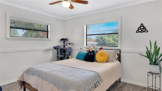 bedroom with a ceiling fan, wood tiled floor, ornamental molding, and baseboards