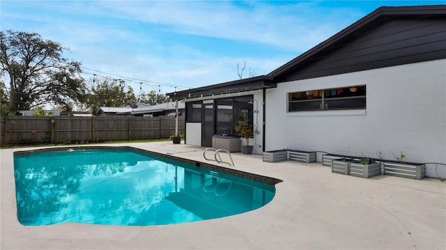 view of pool with fence private yard, a fenced in pool, and a patio