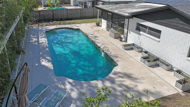 view of swimming pool with a fenced backyard, a fenced in pool, and a patio