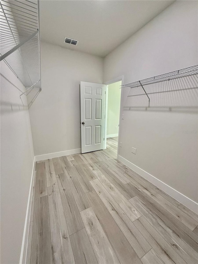 spacious closet with light wood finished floors and visible vents