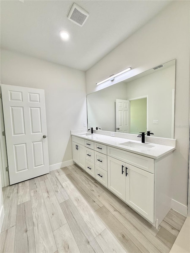 1792 W Lorraine Dr, Citrus Springs, FL 34434 - full bath with double vanity, wood finished floors, and baseboards