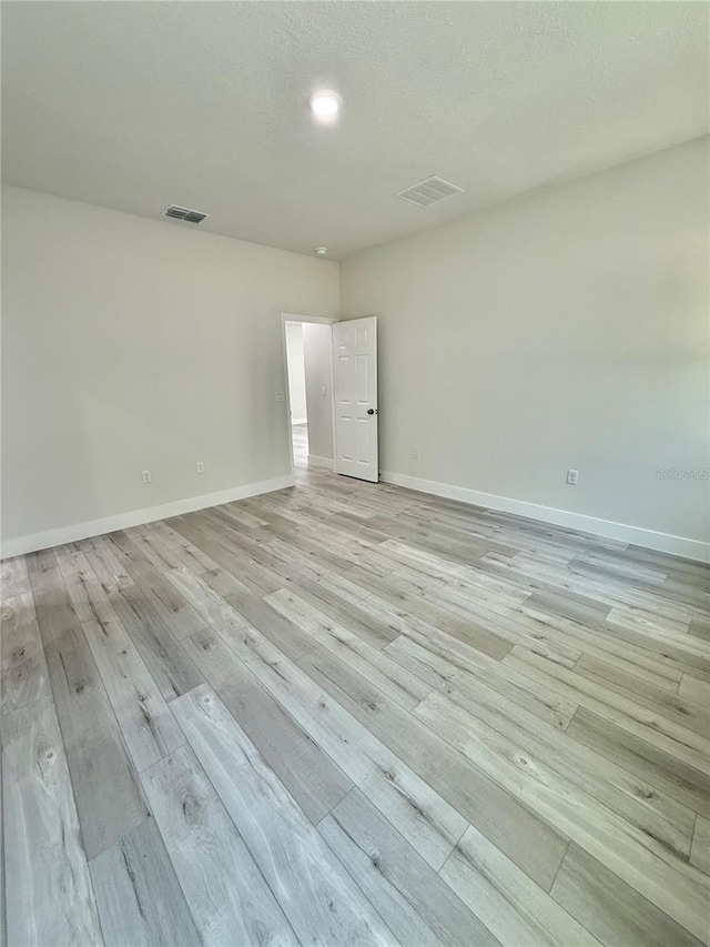 1792 W Lorraine Dr, Citrus Springs, FL 34434 - unfurnished room featuring light wood-style floors, baseboards, and a textured ceiling