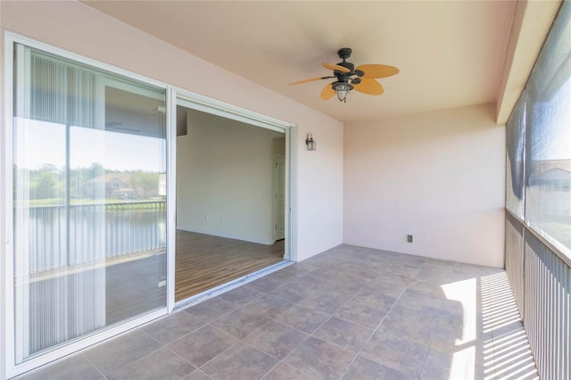 unfurnished sunroom featuring a ceiling fan