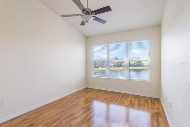 unfurnished room with vaulted ceiling, ceiling fan, baseboards, and wood finished floors